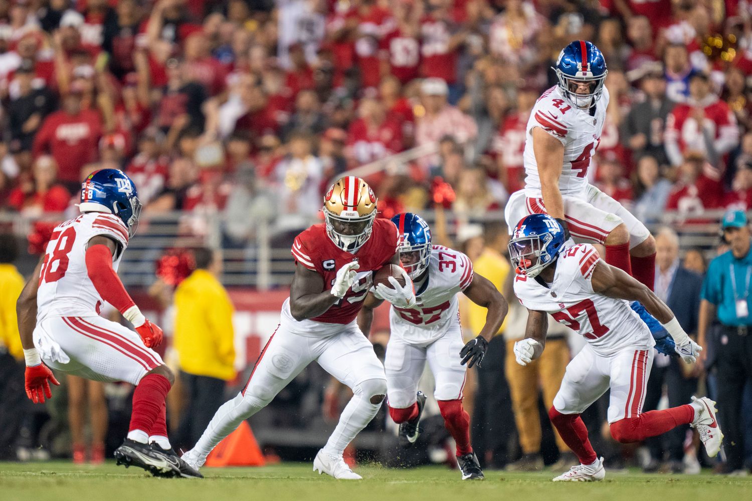 September 21, 2023; Santa Clara, California, USA; San Francisco 49ers wide receiver Deebo Samuel (19) runs the football against New York Giants linebacker Bobby Okereke (58), cornerback Tre Hawkins III (37), linebacker Micah McFadden (41), and safety Jason Pinnock (27) during the third quarter at Levi's Stadium. Mandatory Credit: Kyle Terada-USA TODAY Sports